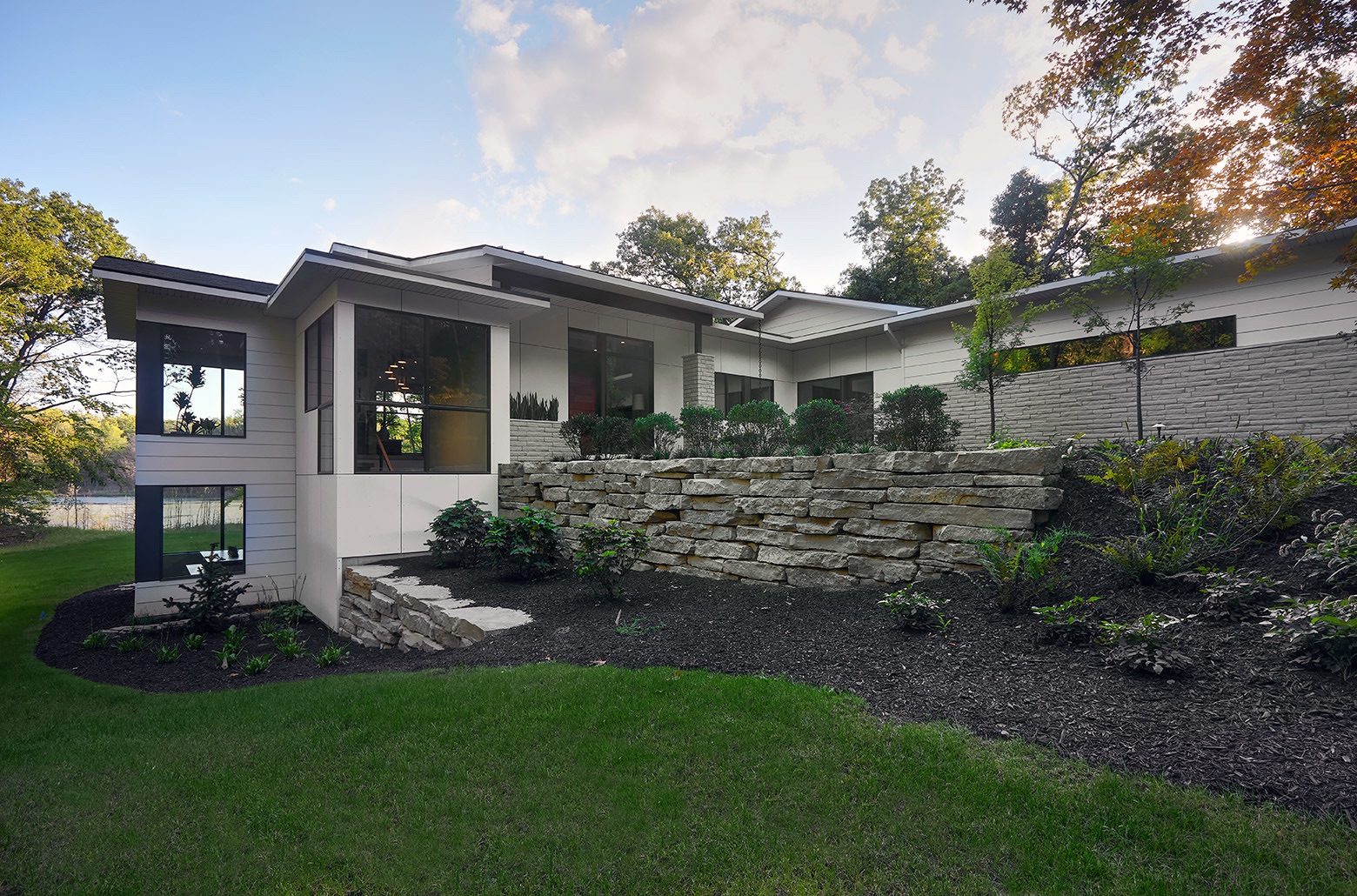 Angle view of white modern home set into a hill