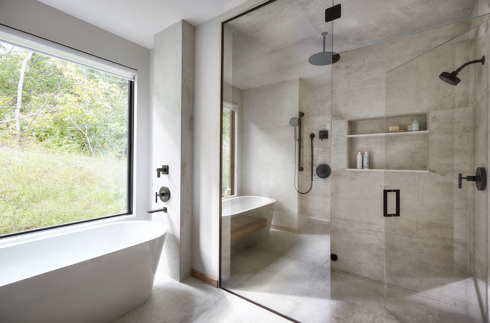 Bathroom with modern aesthetic tub and glass-separated walk-in shower.